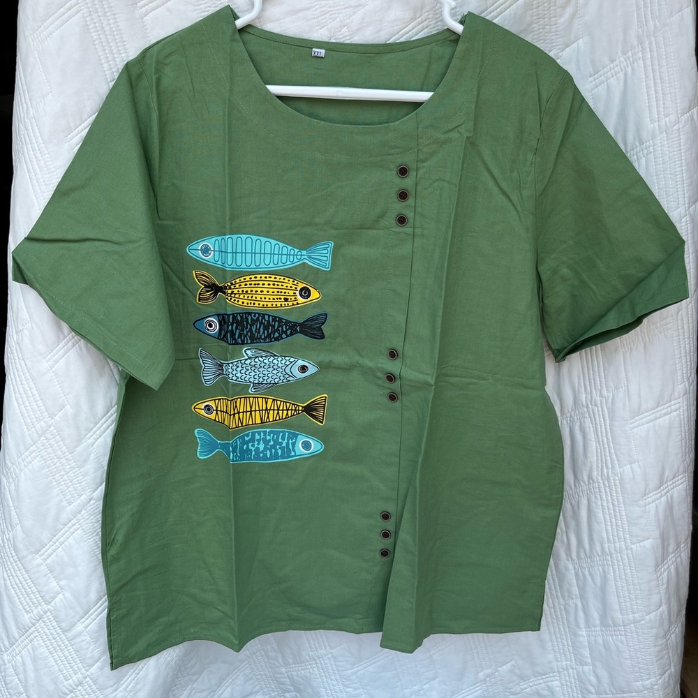 Green blouse with fish.